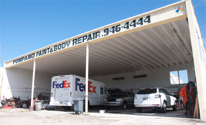 body shop entrance with FedEx trucks